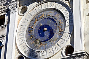 Gold zodiac signs and astronomical clock in a sunny day