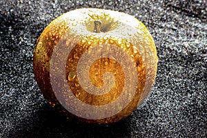 Gold apple on the black texure photo