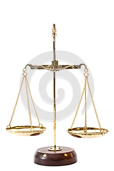 Gold balance scales with metallic chains and wood base used to compare weights, isolated on white background with clipping path