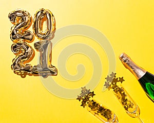 2021 gold balloons and Champagne bottle and flute glasses