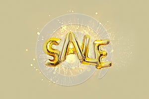 Gold balloons sale with golden fireworks and explosion on beige background. Sale flies with sparks, creative idea. Promotion
