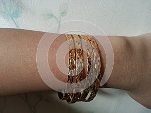 Gold bangals in wrist