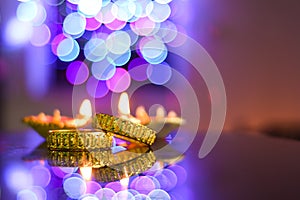 Gold bangles on the foreground of beautifully illuminated lights