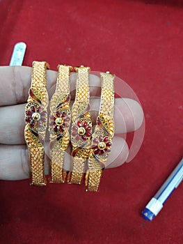 Gold bangles for indian women vings flowers in each of them