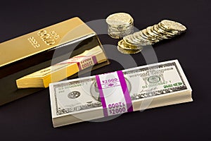 Gold bar and coins on black