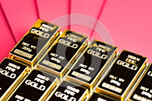 Gold bar, ingot or bullion on red envelope using as financial asset, saving or investment concept