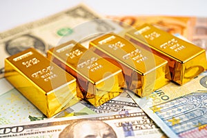 Gold bar on US dollar and Euro banknote, economy finance exchange trade investment