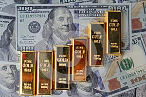 Gold bars arranged as a graph exponential on bank note .