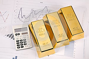 Gold bars and calc closeup on white background photo