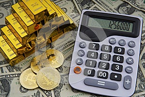 Gold bars with calculator on dollar bills background and bitcoin digital cryptocurrency coin