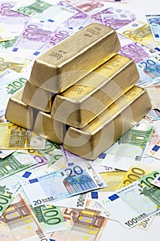 Gold bars on heap of euro notes