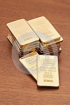 Gold Bars on Wood Surface