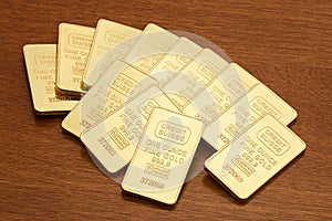 Gold Bars on Wood Surface