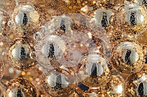 Gold beads in the wine glass with water, bubbles, macro, photo, background for design