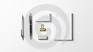 A gold binder clip an eraser and a notepad. The notepad features predefined