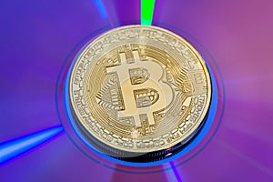 Gold bitcoin on blue reflection