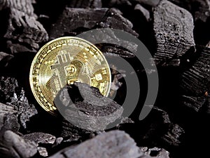 Gold bitcoin on a coal`s background. Mayerized Crypto currency. Payroll through the Internet. To drip crypto currency bitcoin. The