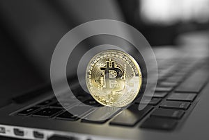 Gold Bitcoin crypto coin on a laptop keyboard. Exchange, bussiness, commercial. Profit from mining crypt currencies