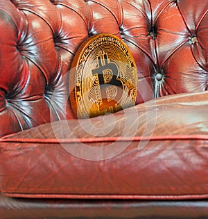 Gold bitcoin cryptocurrency lost down sofa armchair