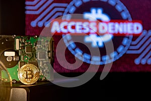 Gold Bitcoin with hard disk, access denied screen in the backgro