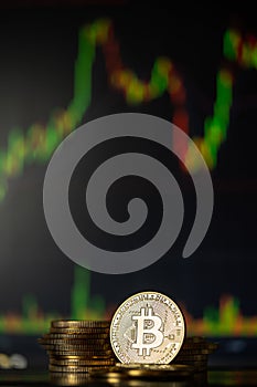 Gold Bitcoins with candle stick graph chart and digital background
