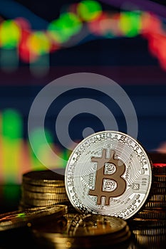 Gold Bitcoins with candle stick graph chart and digital background