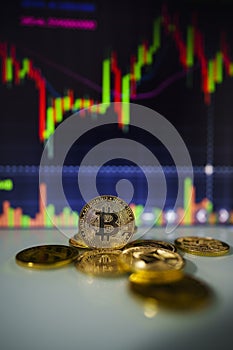 Gold Bitcoins with candle stick graph chart and digital background