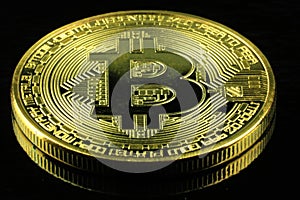 Gold Bitcoins cryptocurrency money on a black background