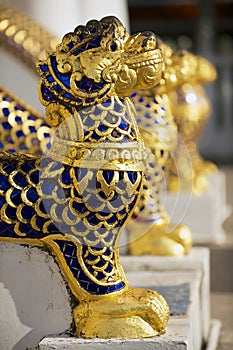 Gold and blue stones covered animal figures at the entance to the Phra Mahathat Vihan in Nakhon Sri Thammarat, Thailand. photo
