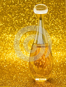 gold bottle parfume close-up dior bokeh background photo