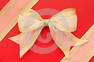 Gold bow on red background.