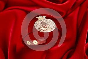 Gold bracelet on a red background with copy space