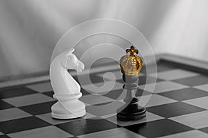 gold, bronze crown on black pawn, duel queen figures, horse on chessboard blackboard, concept supreme power, victory, symbol