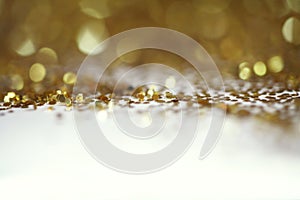 Gold bronze glitter shine dots confetti. Abstract light blink sparkle defocus backgound