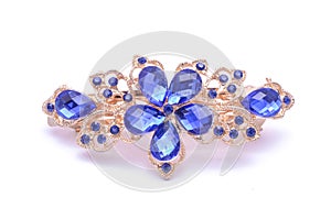 Gold brooch with blue stones isolated on white