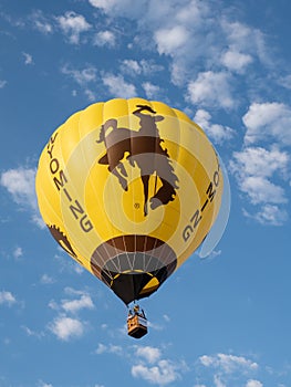 A Wyoming Hot Air Balloon with Bucking Bronco Flying at Big Sky