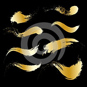 Gold brush stroke paint set isolated on black background
