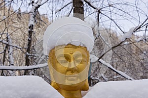 Gold Buddha covered with snow