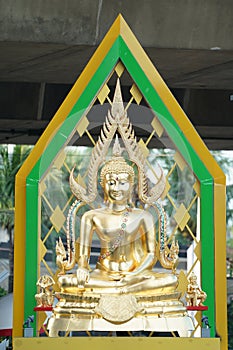 Gold buddha statue with artifact green aura behind