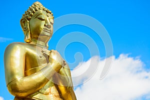 Gold Buddha Statue on blue sky background