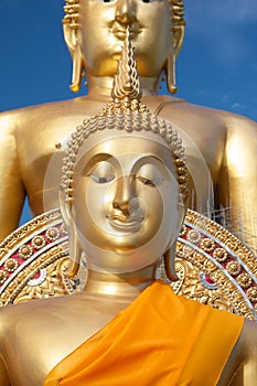 Gold buddha statue in Thai temple with clear sky.WAT MUANG, Ang Thong, THAILAND.