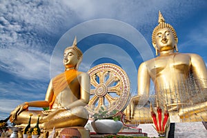 Gold buddha statue under construction in Thai temple with clear sky.WAT MUANG, Ang Thong, THAILAND.