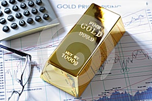 Gold bullion bar on a stocks and shares chart photo