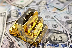 Gold bullion over 100 us dollar money, investment and wealth concept