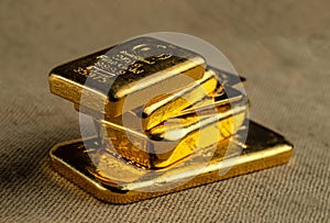 Gold bullion. A stack of gold bars of various weights.