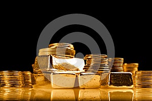 Gold bullions and stack of coins. Background for finance banking concept. Trade in precious metals.