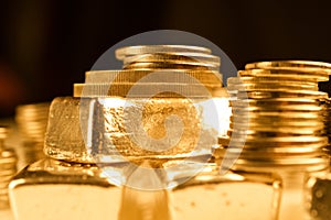 Gold bullions and stack of coins. Background for finance banking concept. Trade in precious metals.