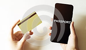 Gold card and phone with text disaster recover plan Passport in the female hands