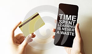 Gold card and phone with text disaster recover plan Time Spent Learning Is Never A Waste in the female hands