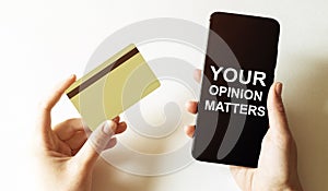 Gold card and phone with text disaster recover plan Your Opinion Matters in the female hands